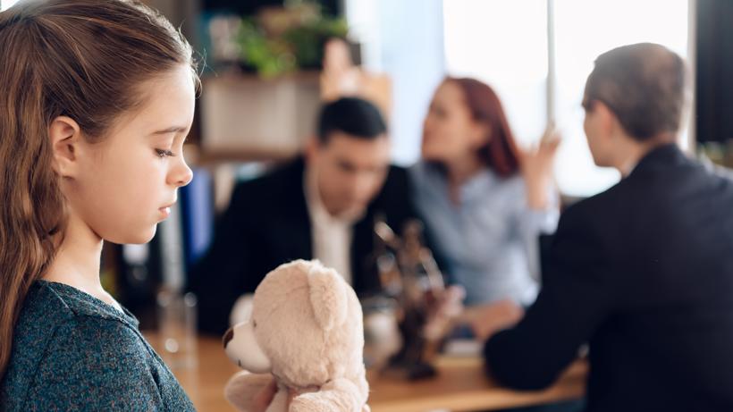 A forlorn child and arguing parents in a Fayetteville Georgia family lawyers office.