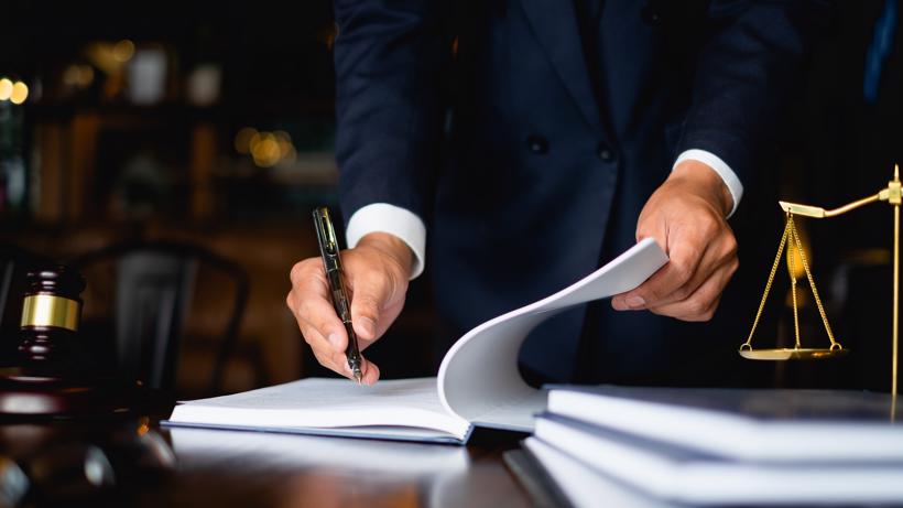 A Fayetteville car accident lawyer filling out legal documents.