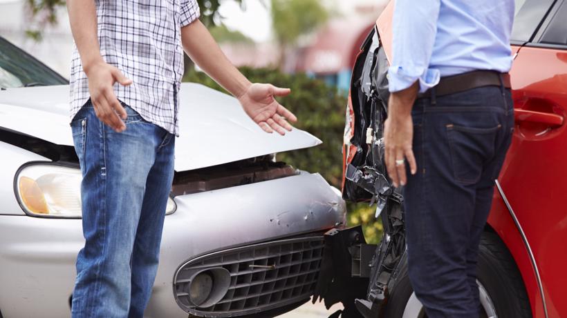 Two drivers arguing after a car accident.