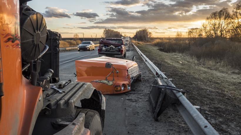 A truck that lost its hood in an accident on the highway.