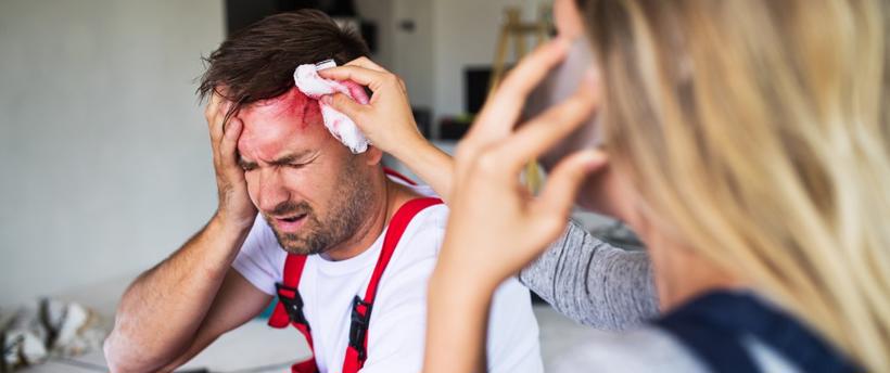 This image shows a woman assisting a man after he suffered a brain injury.