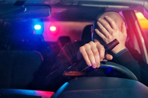 Man being pulled over by police for drunk driving, concept of Fayetteville drunk driving accident lawyer