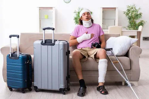 What Should I Do If I Get Injured In A Car Accident While Out-Of-State? Injured man with suitcase - out of state