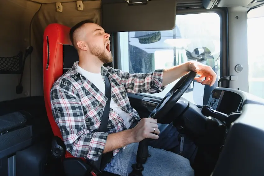 How Trucking Company Negligence Causes Serious Accidents in Georgia Fatigued commercial truck driver at the wheel illustrating hours of service violations that cause serious accidents