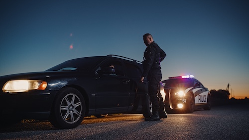 Does a Traffic Ticket Affect Your Car Accident Claim in Georgia? Police Pulling Over Car