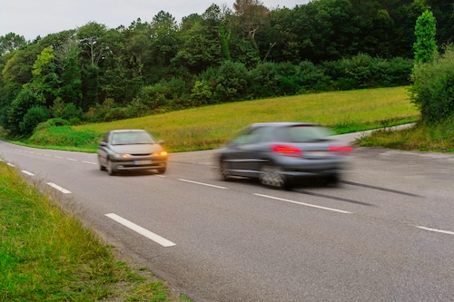 Car About To Turn Left While Other Car Speeds