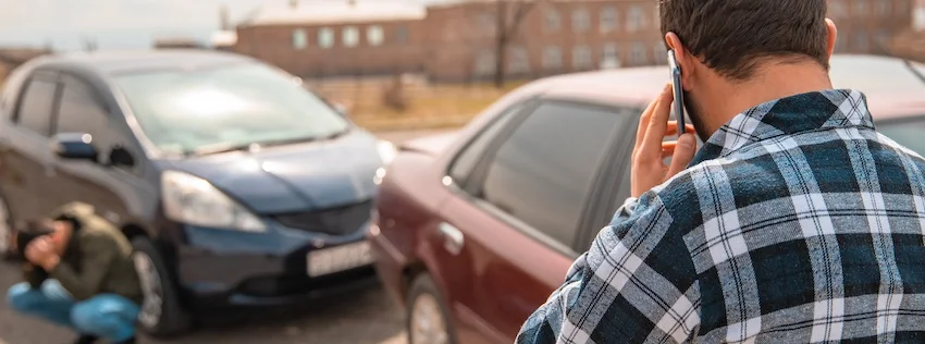 Atlanta Car Accident Lawyer A man is calling a car accident lawyer from Wade Law office Injury Lawyer after being in a car wreck.