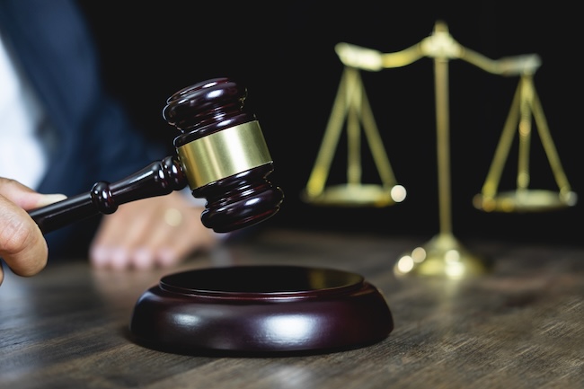 Judge's gavel striking in courtroom representing punitive damages awarded against reckless drivers