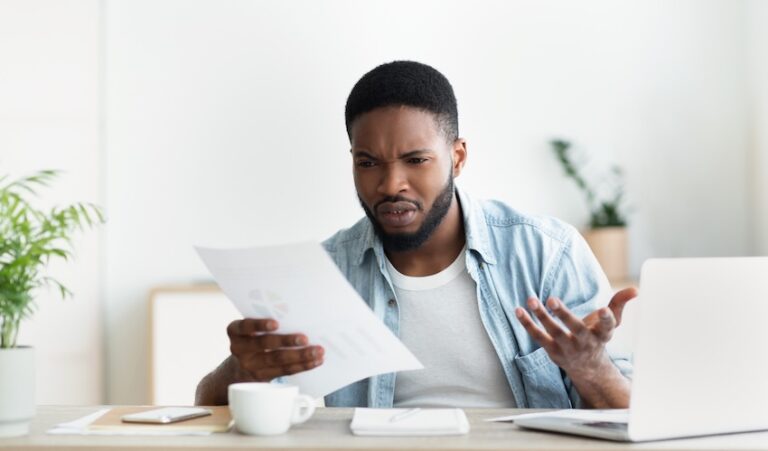 Georgia car accident victim reviewing inadequate settlement offer at home