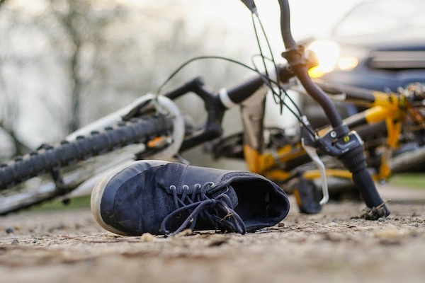 Fayetteville Bicycle Accident Lawyer A bike lying on the road after being hit by a car represents a Fayetteville bicycle accident lawyer.
