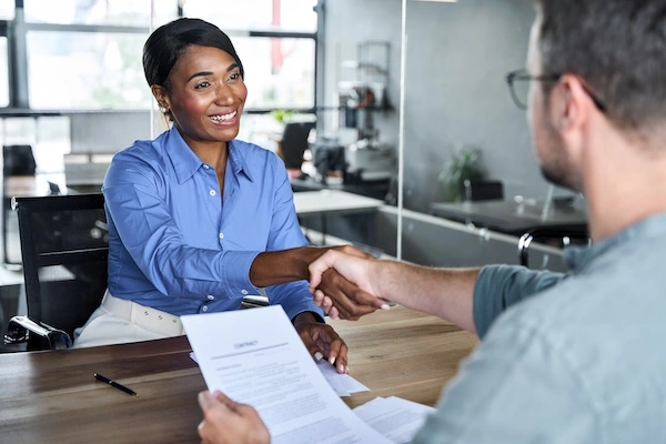 Fayetteville Truck Accident Lawyer A Fayetteville truck accident lawyer is shaking hands with a client at Wade Law Office Injury Lawyer.